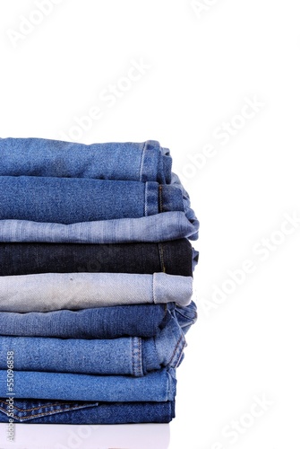 stack of different kind of blue jeans, on white background