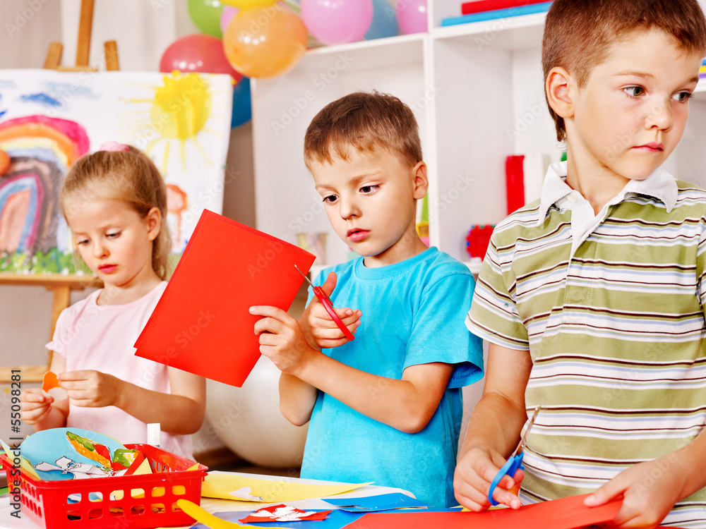 Fototapeta premium Children cutting out scissors paper.