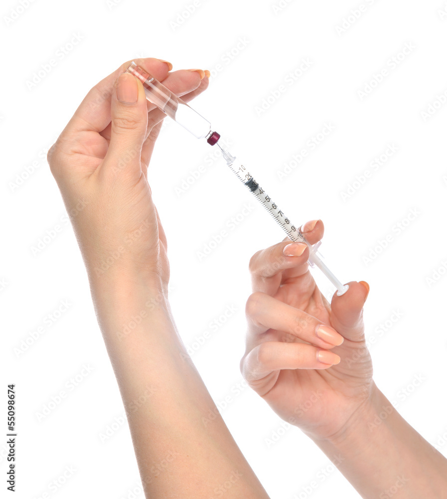 Doctor hands with medical syringe with needle in ampule Doctor hands with medical syringe with needle in ampule