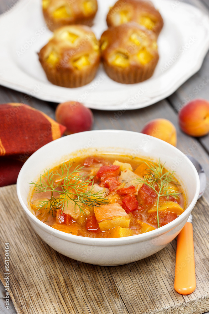 Bowl of tomato and pepper soup on wooden table. Autumn setting. Bowl of tomato and pepper soup on wooden table. Autumn setting.
