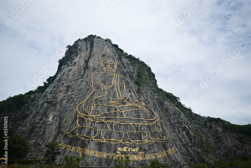 THE LASER CLIFF BUDDHA IMAGE AT KHAO CHEE CHAN, PATTAYa, THAILAN photo