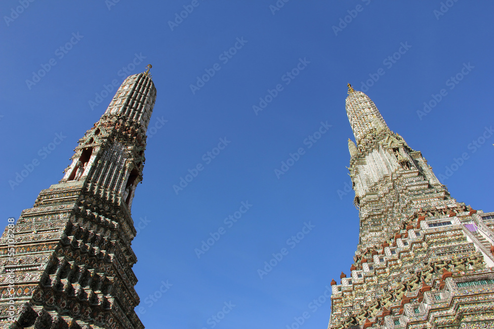 two pagodas at Wat Arun Rajwararam against blue sky