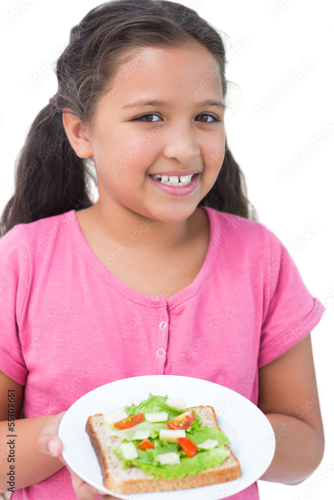Little girl showing her sandwich to camera