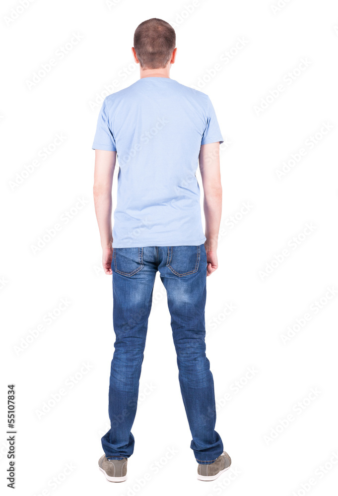 Back view of young man in t-shirt and jeans looking. Back view of young man in t-shirt and jeans looking.