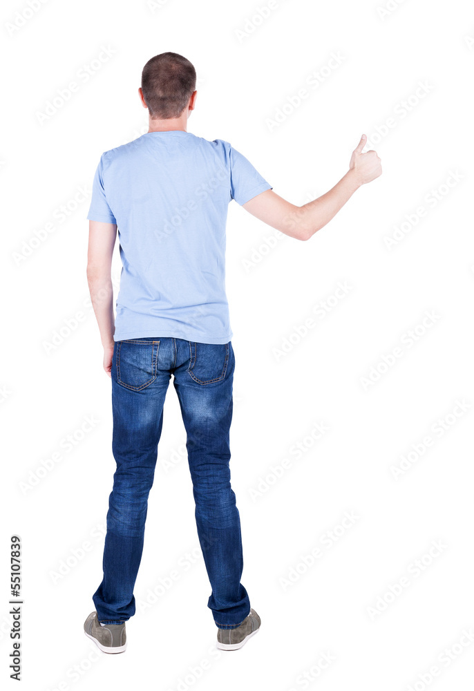 Back view of man in t-shirt. shows thumbs up. Back view of man in t-shirt. shows thumbs up.