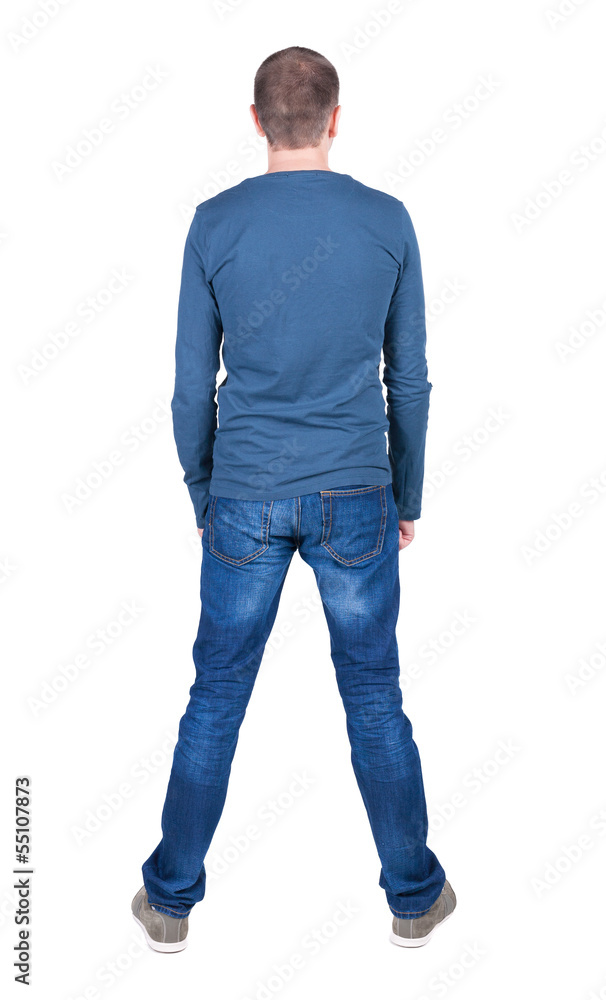 Back view of young man in t-shirt and jeans looking Back view of young man in t-shirt and jeans looking