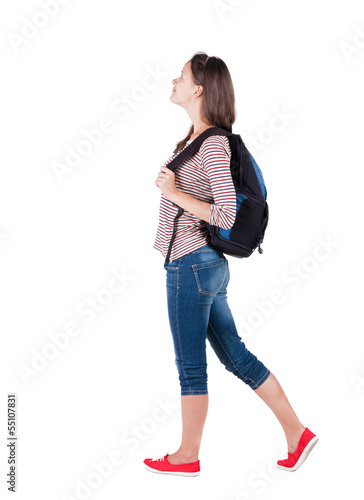 back view of standing young beautiful brunette woman with backp