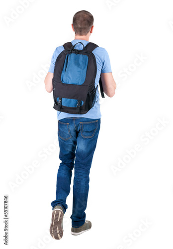 back view of walking  man  with backpack.
