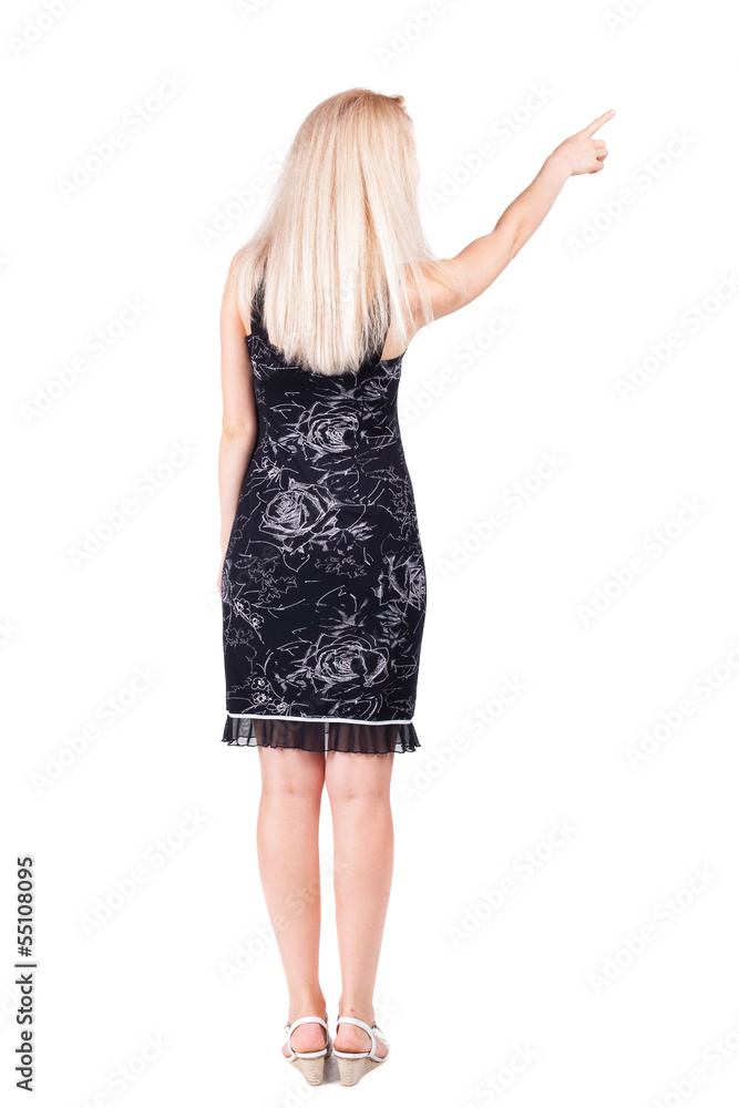 Back view of young blonde woman pointing at wall. Back view of young blonde woman pointing at wall.