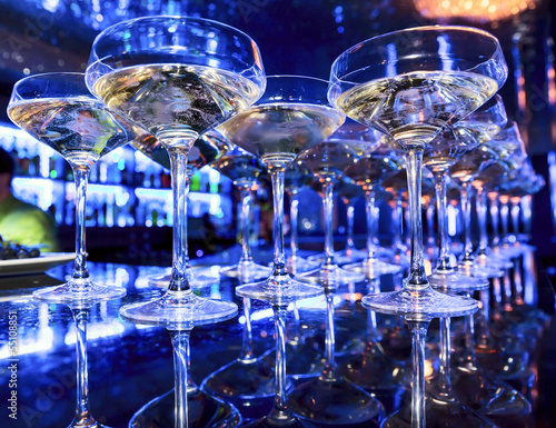 Glasses of champagne on bar