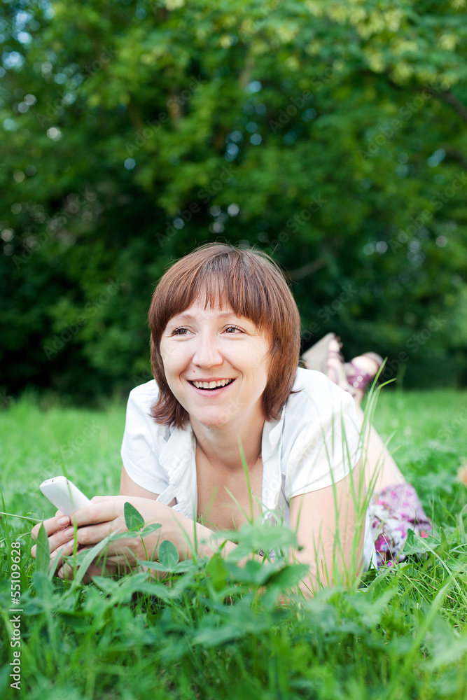 Smiling young woman with mobile outdoor Smiling young woman with mobile outdoor