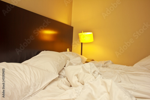 Hotel bed after use.