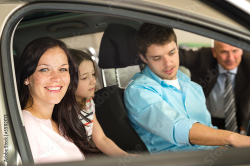 Family sitting in car in retail store © CandyBox Images