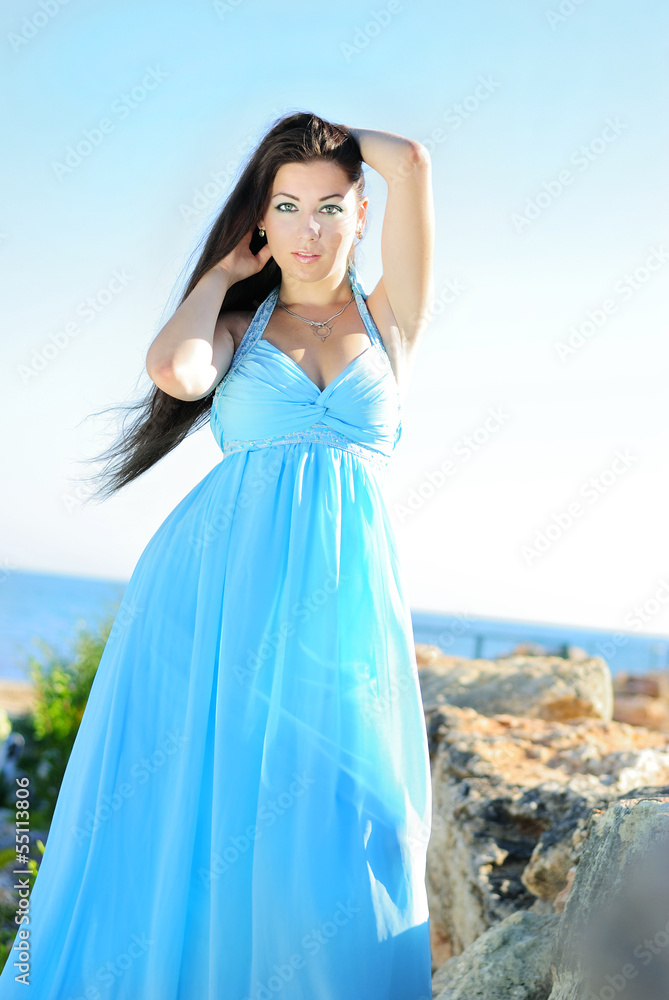 The beautiful girl with long hair on stones The beautiful girl with long hair on stones