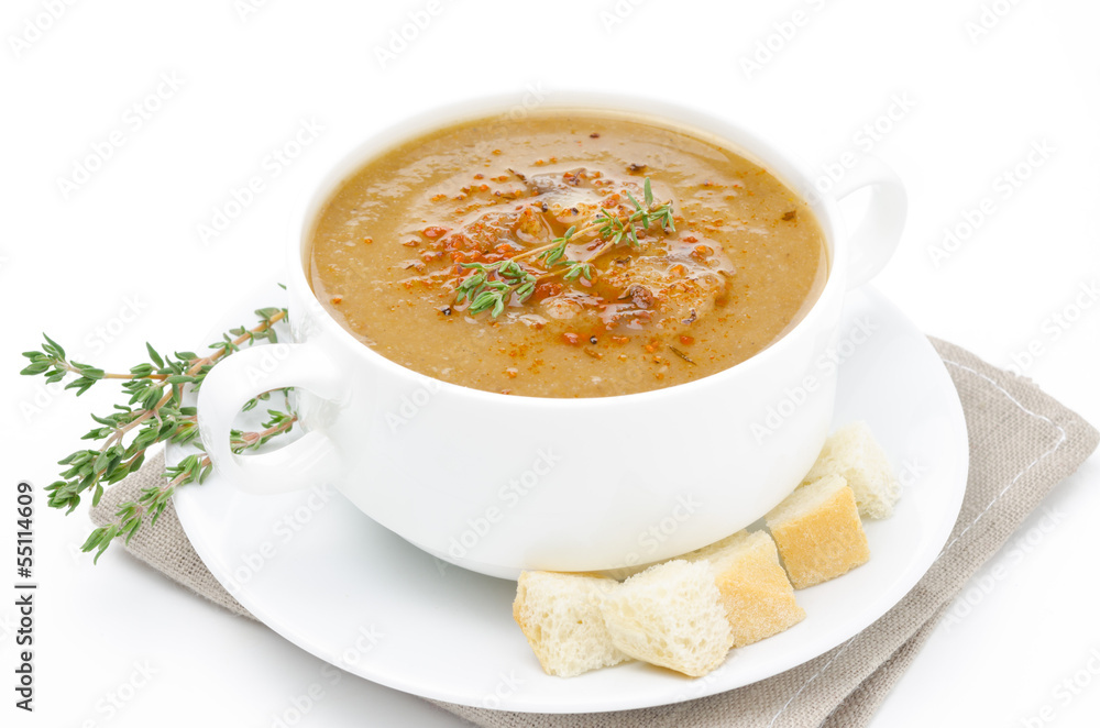 Mushroom soup in bowl with croutons and thyme isolated on white Mushroom soup in bowl with croutons and thyme isolated on white