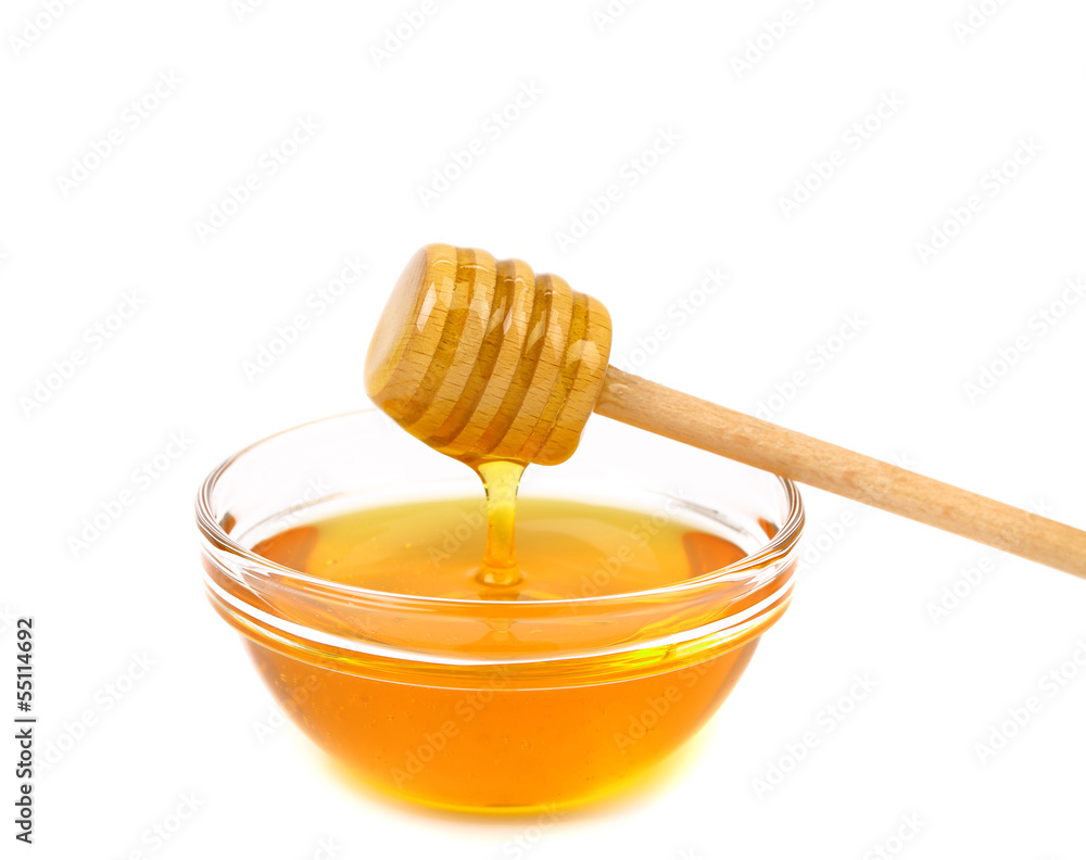 Honey dripping from a wooden dipper Honey dripping from a wooden dipper
