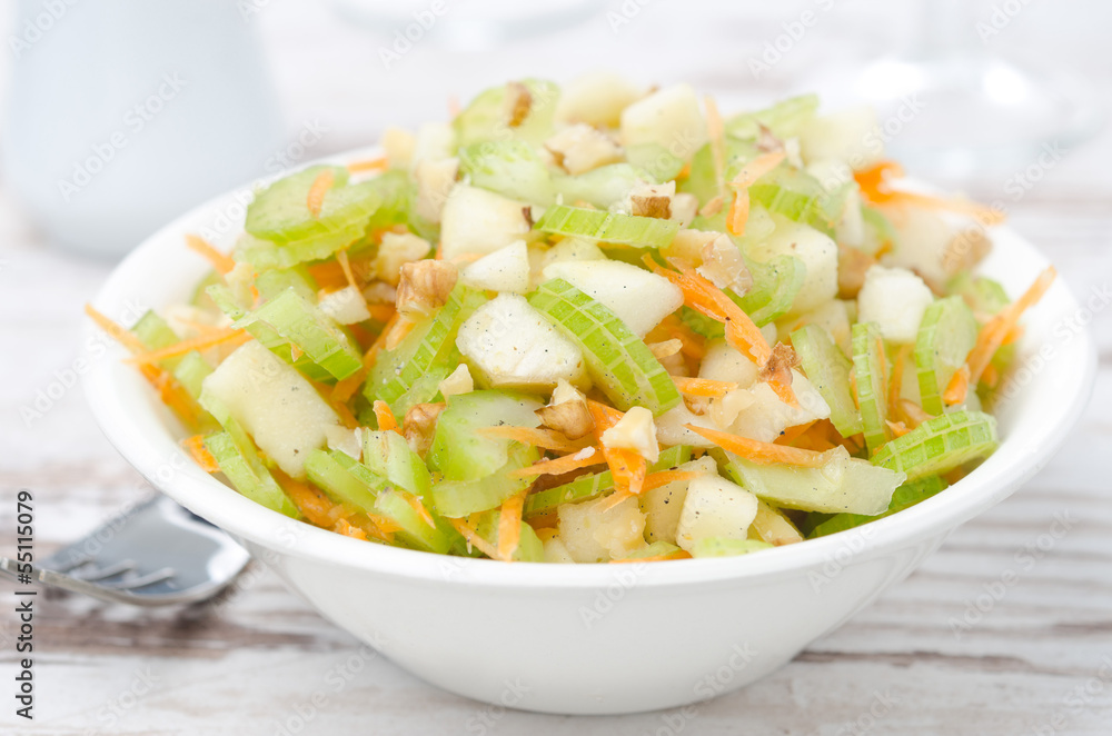 salad with celery, carrots and apples closeup