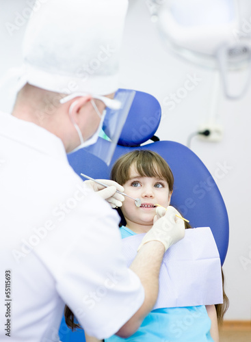 little girl during inspection of oral cavity