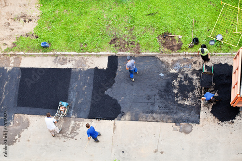 workers laid asphalt on urban road photo