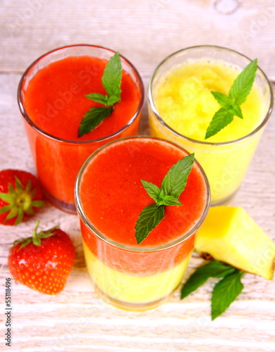 Strawberry and pineapple smoothie in glass mixed