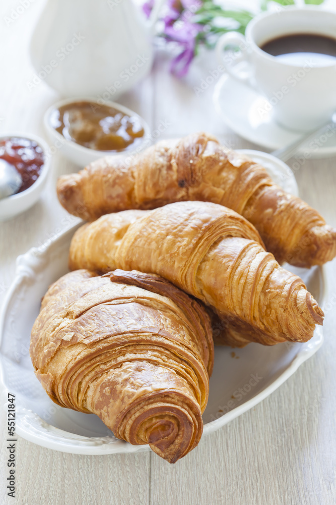 Croissants on table with jam and coffee Croissants on table with jam and coffee