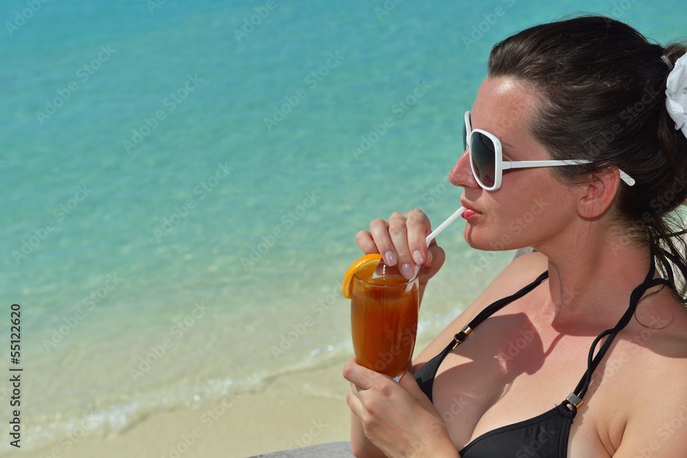 Beautiful young woman with a drink by the sea Beautiful young woman with a drink by the sea