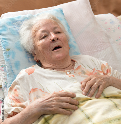 Senior woman lying at bed