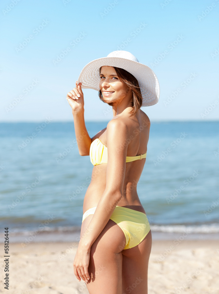 girl in bikini standing on the beach