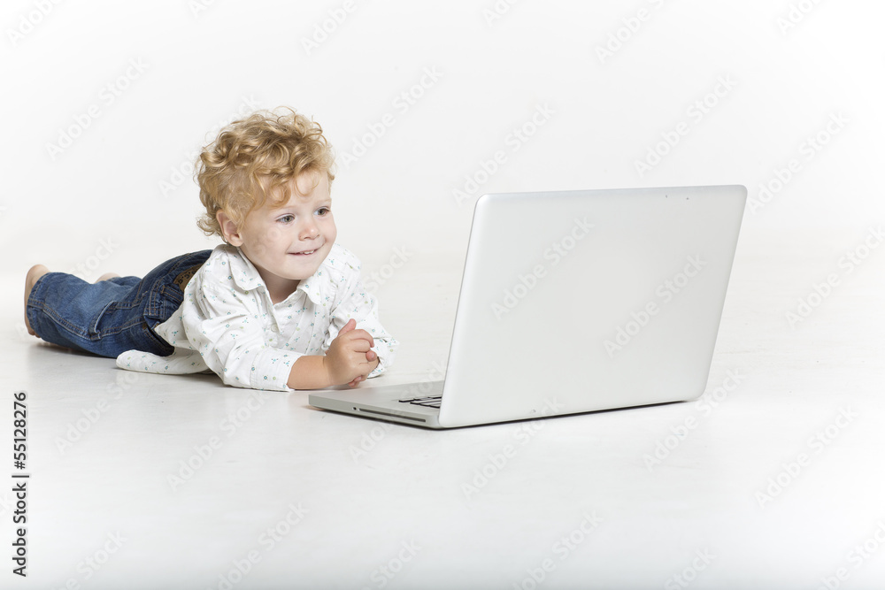 Happy toddler playing with laptop Happy toddler playing with laptop