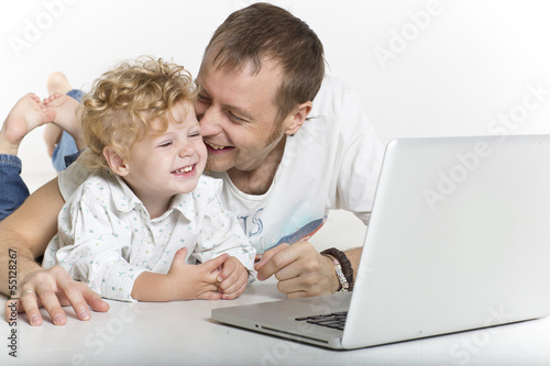 Father and his baby son on computer
