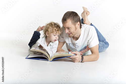 Father and son are looking into a story book