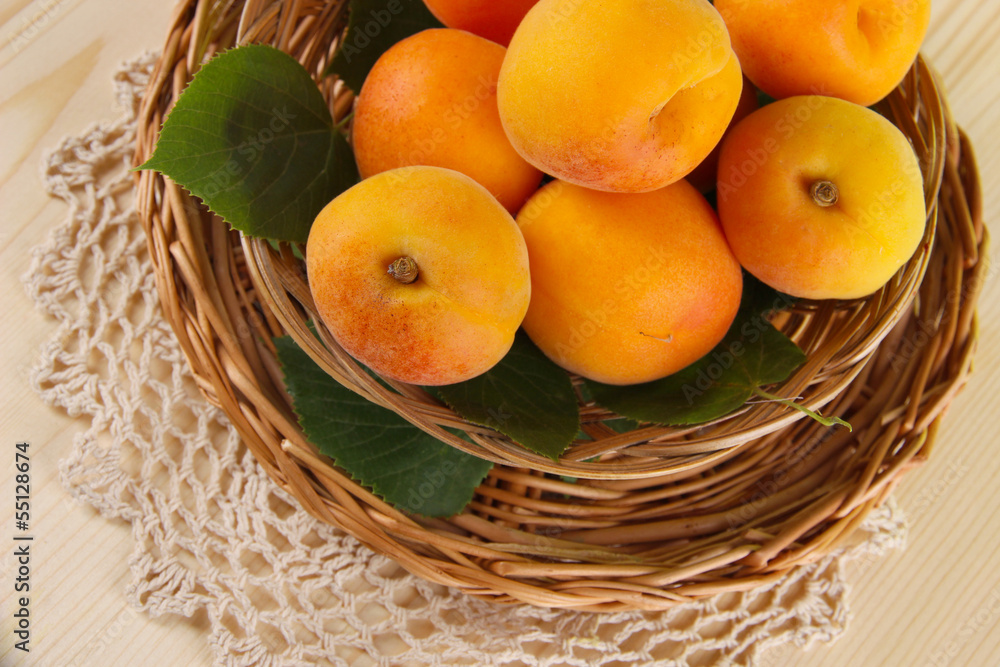 Apricots on wicker coasters on napkin on wooden table Apricots on wicker coasters on napkin on wooden table