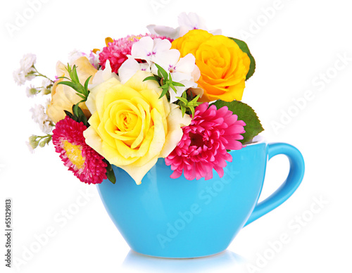 Beautiful bouquet of bright flowers in color mug, isolated