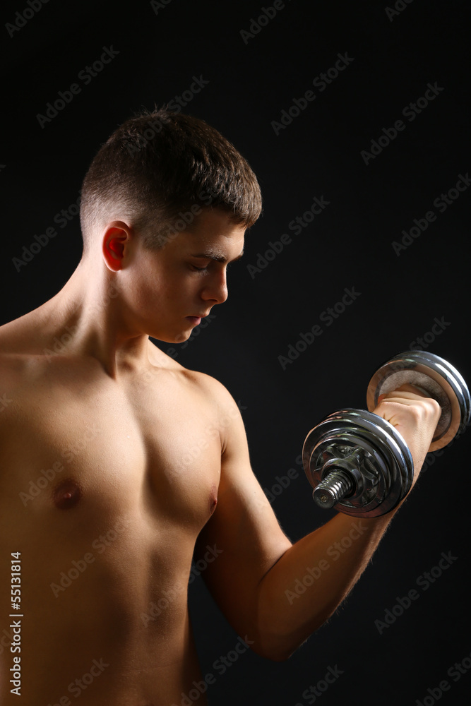 Handsome young muscular sportsman execute exercise with Handsome young muscular sportsman execute exercise with
