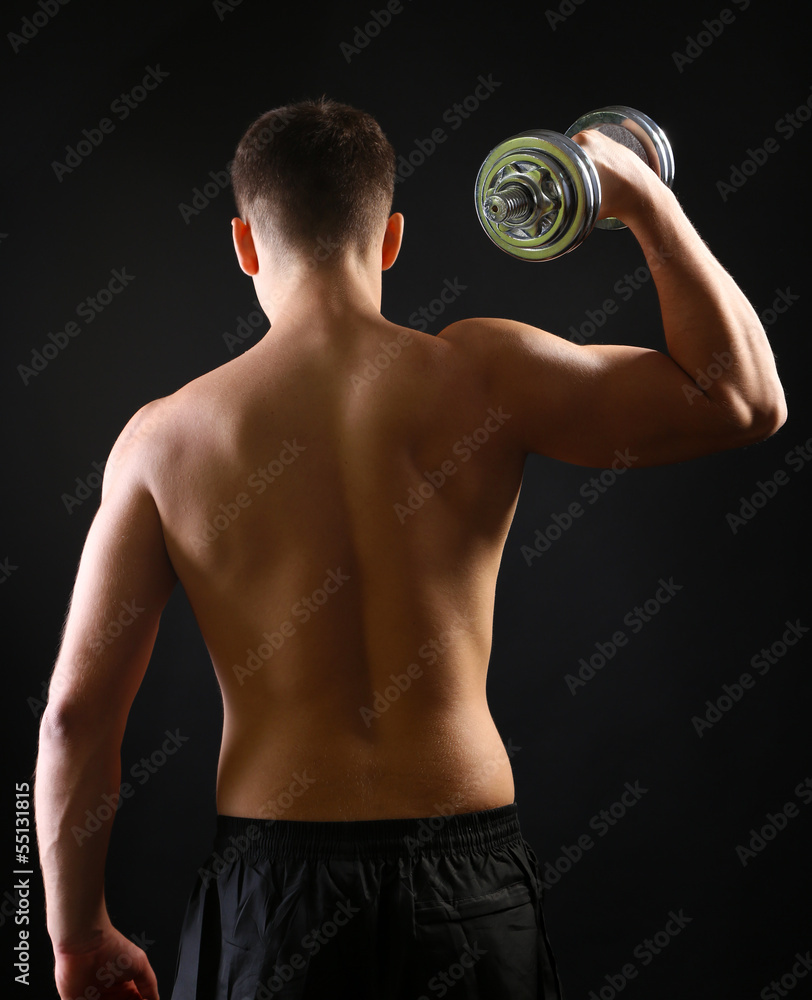 Handsome young muscular sportsman execute exercise with Handsome young muscular sportsman execute exercise with