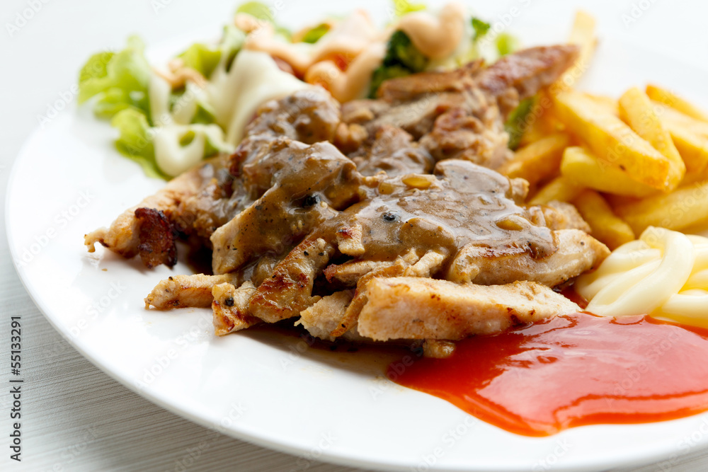 grilled pork steak with potato and salad