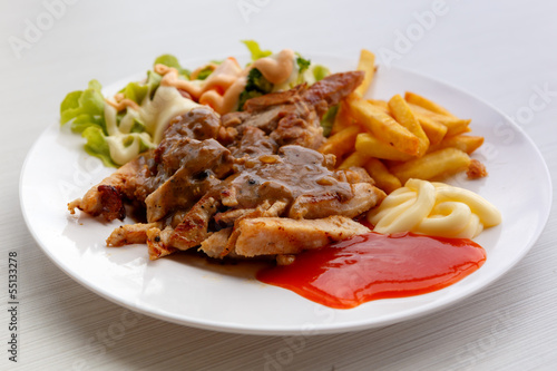 grilled pork steak with potato and salad