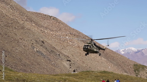 Helicopter sits in the mountains photo