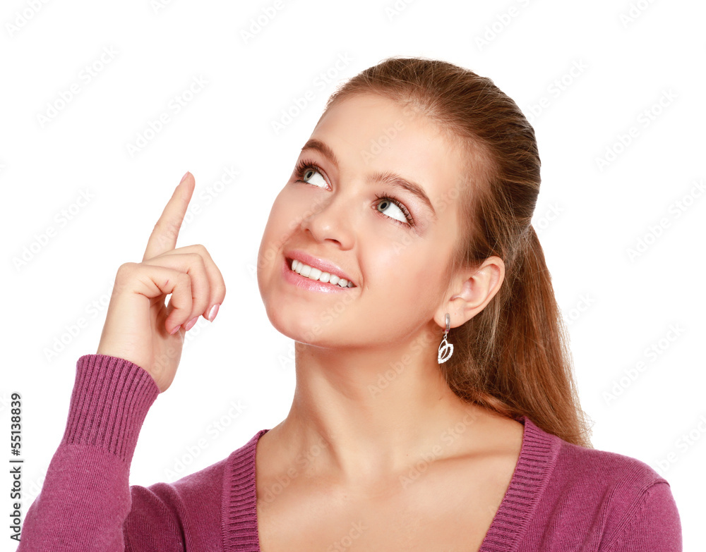 Portrait of a smiling young woman pointing up Portrait of a smiling young woman pointing up