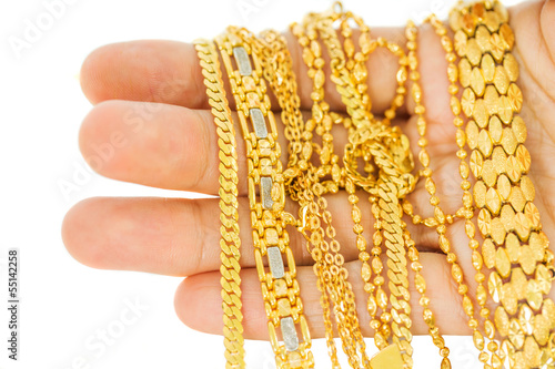 Woman hand holding gold chains