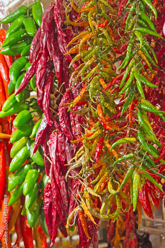 Fotografie Green and red sharp peppers
