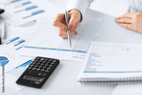 woman hand with calculator and papers