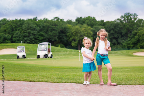 Cute little gilrs on the golf course