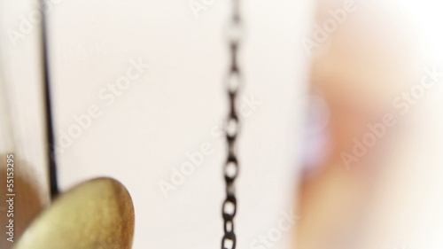 Pendulum of a grandfather clock swinging