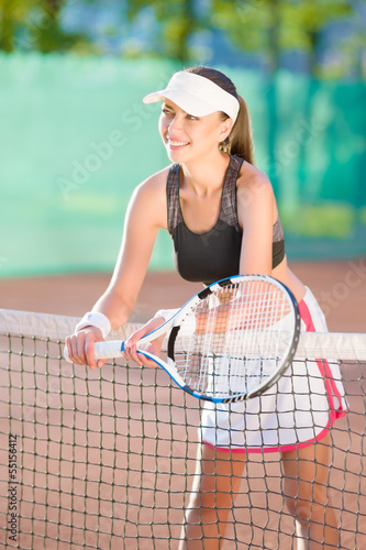 Portrait of positive looking female tennis athlete with racquet © danmorgan12