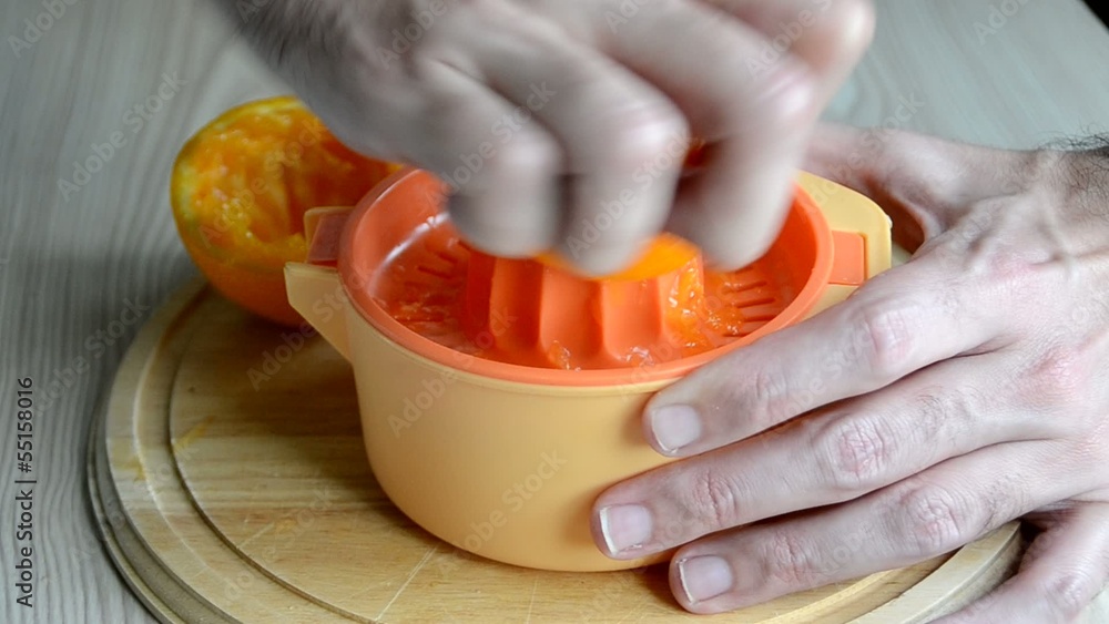 Un hombre preparando un zumo de naranja