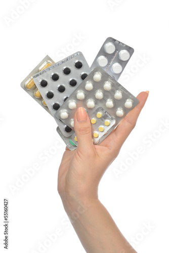 Hand holding packs of medicine aspirin painkiller tablet pills