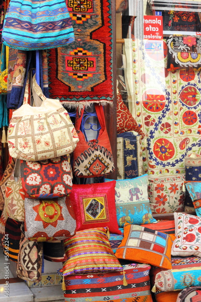 Fabrics, textiles and turkish rugs at a bazaar in Turkey
