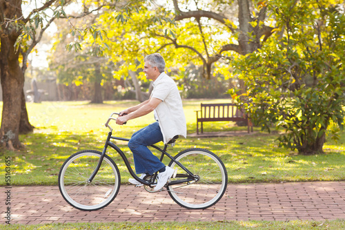 mid age man riding bicycle