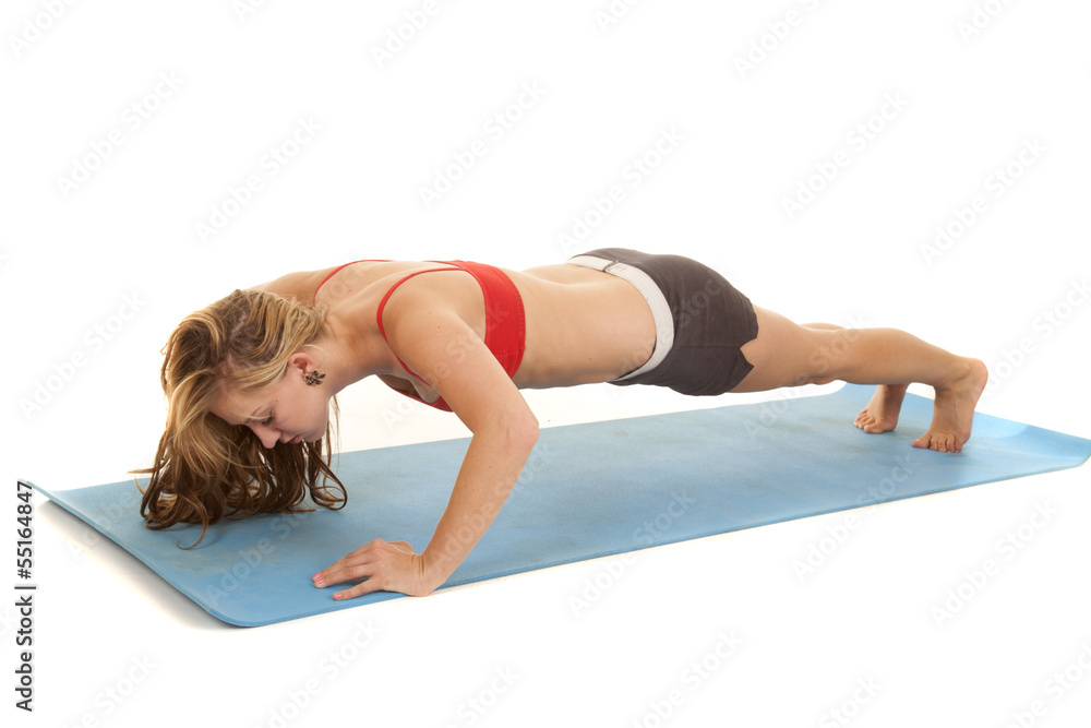 Woman red sports bra doing a pushup Woman red sports bra doing a pushup